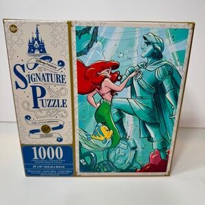 NWT. Disney Parks Signature Puzzle featuring the Little Mermaid and Prince Eric.